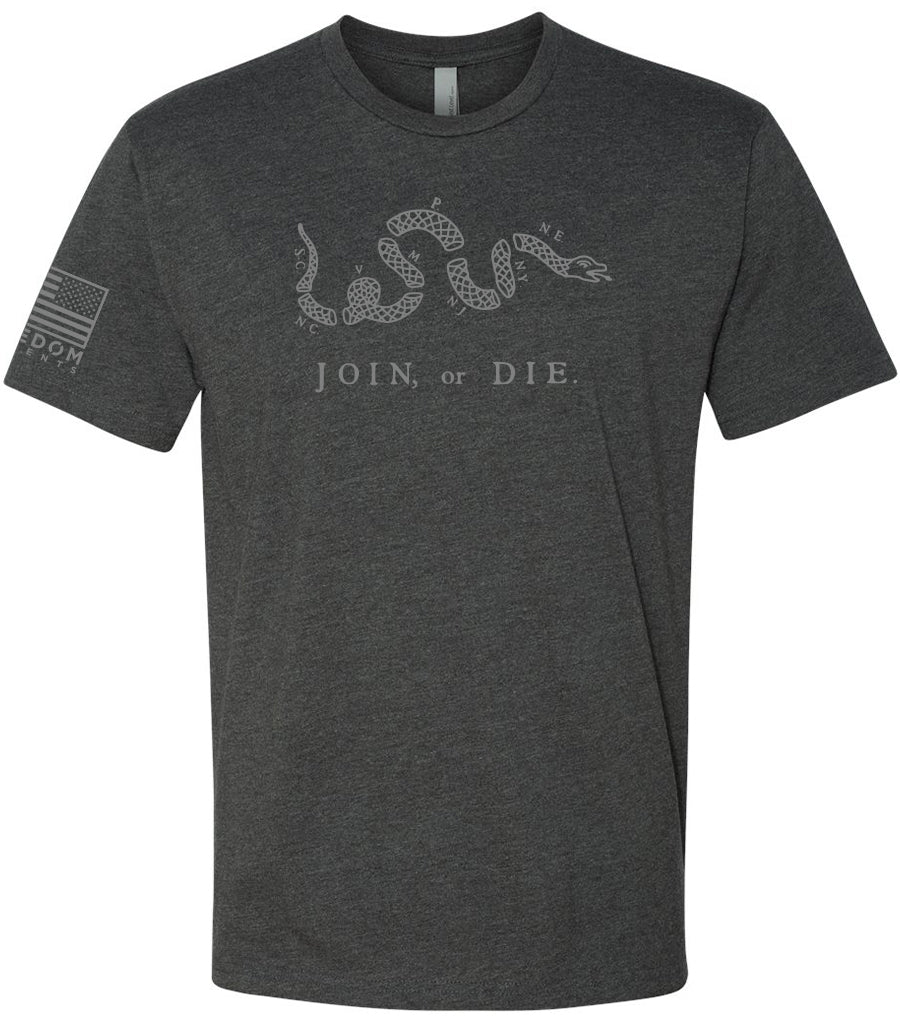 "A Charcoal Join or Die T-shirt in gray print, with the American Flag on the right Sleeve that says Freedom Elements, shirt shows the rattle snake in eight sections like Bejamin Fanklin's early sketches"