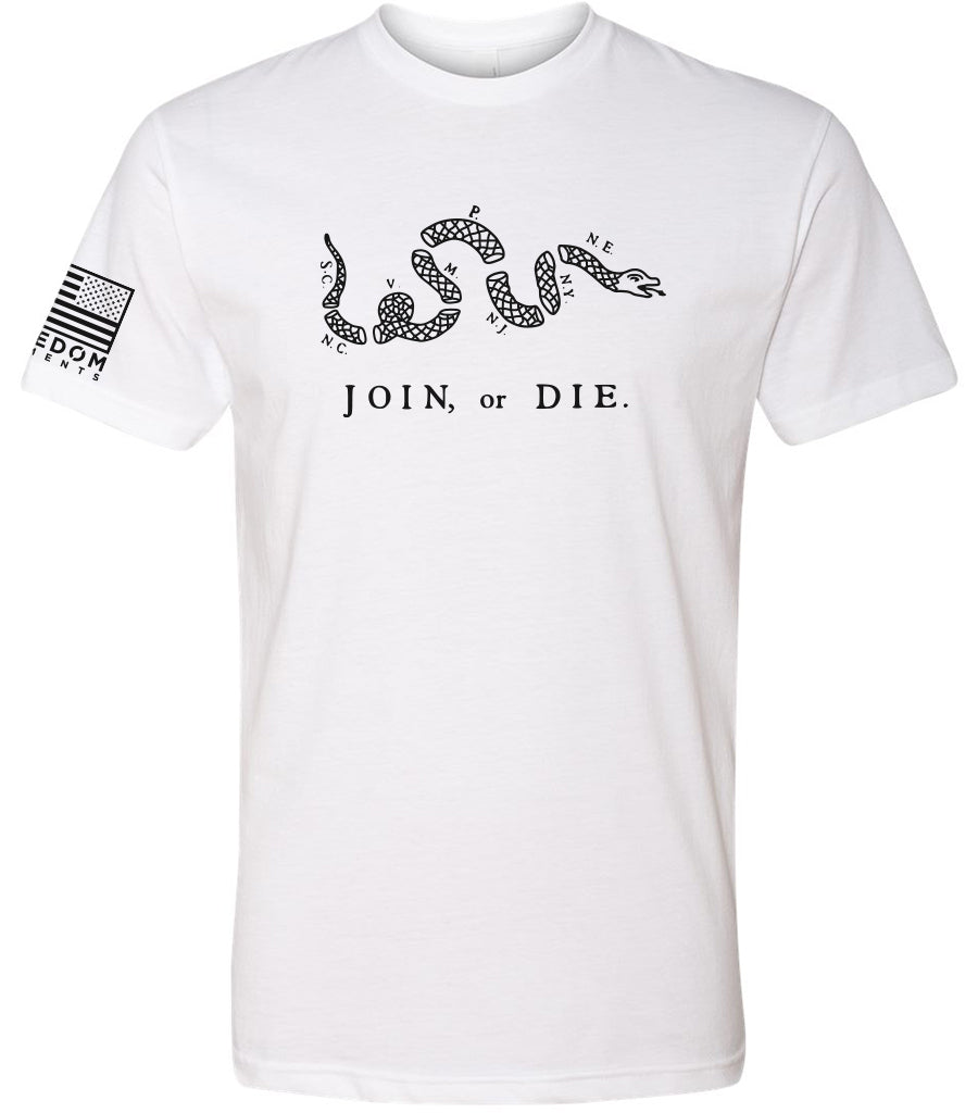 "A White Join or Die T-shirt in black print, with the American Flag on the right Sleeve that says Freedom Elements, shirt shows the rattle snake in eight sections like Bejamin Fanklin's early sketches"